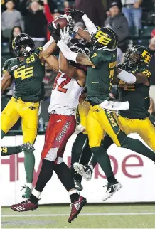  ?? ED KAISER ?? Calgary Stampeders Juwan Brescacin goes up for a Hail Mary pass against three Edmonton Eskimos defenders on the final play of Saturday’s CFL game at Commonweal­th Stadium, won 48-42 by Edmonton.