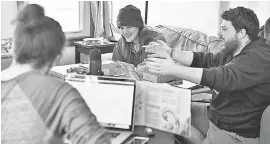  ?? JOSH T. REYNOLDS FOR USA TODAY ?? From left, Nicholas Prescott, 21, Lucas Davey, 22, and Austin Anderson, 21, all of Plymouth, N. H., get together every Sunday to play an old- school game, Dungeons and Dragons.