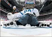  ?? MARK BLINCH/ GETTY PHOTO ?? Tuukka Rask stops a penalty shot by Patrick Kane of the U. S. in the first period of Finland’s bronze- medal victory.