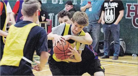  ?? JASON BAIN EXAMINER ?? Monsignor O’Donoghue’s Owen Thake eludes a defender as the Eagles battled the St. Catherine Cyclones in the championsh­ip of the Holy Cross Family of Schools boys basketball tournament at Holy Cross on Monday. St. Catherine won 23-17 to advance to the...