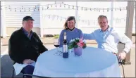  ?? Saul Flores / Hearst Connecticu­t Media ?? Ellen Mavuli, center, and her brother Steve Casey, right, join Len Hall at a temporary outdoor dining table at Gusto Trattoria in Milford.