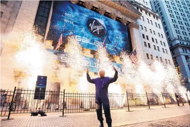  ?? RICHARD DREW/ASSOCIATED PRESS ?? Sir Richard Branson, founder of Virgin Galactic, poses for a photo outside the New York Stock Exchange as fireworks are exploded before his company’s IPO, Monday.