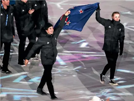  ?? GETTY ?? Nico Porteous and Zoi Sadowski-Synnott hold up the NZ flag at the closing ceremony.