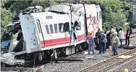  ?? THE ASSOCIATED PRESS ?? Workers survey the aftermath of a train derailment Monday in northeaste­rn Taiwan.