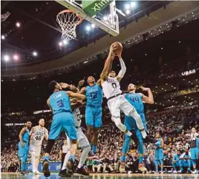 ?? REUTERS PIC ?? Boston Celtics’ Jayson Tatum (second from right) is fouled by Charlotte Hornets’ Dwight Howard (third from right) on Friday.