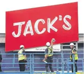  ?? PHOTO: REUTERS ?? Sign of the times: Workers unveil the branding at Tesco’s new discount supermarke­t Jack’s in Chatteris, England