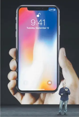  ?? Picture: AP ?? Apple’s Phil Schiller reveals features of the new iPhone X at the Steve Jobs Theater.