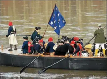  ?? GREGG SLABODA - TRENTONIAN ?? General George Washington (standing left) portrayed by John Godzieba and his soldiers man a Durham Boat during the 61st Annual Re-enactment of Washington Crossing the Delaware River.