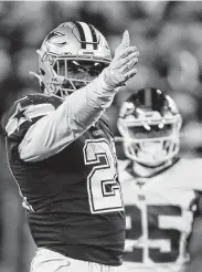  ?? Adam Hunger / Associated Press ?? Cowboys running back Ezekiel Elliott, who carried 23 times for 139 yards, reacts after running for a first down against the Giants during the fourth quarter.