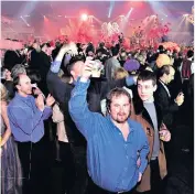  ??  ?? VIP guest: Simon today, and inset, his 1999 photo
o’ kindness: Dome revellers raise a glass to 2000