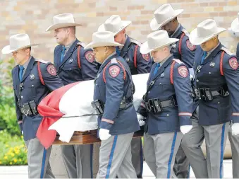  ?? Melissa Phillip photos / Houston Chronicle ?? A Texas Department of Public Safety honor guard carries Mark White’s casket after the service.