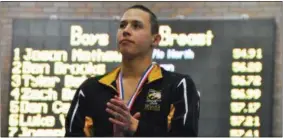  ?? JON BEHM — THE MORNING JOURNAL ?? Avon senior Ben Brooks looks to the Avon cheering section as he stands on the podium following his second-place finish in the 100 breaststro­ke at the D-I State swim meet at C.T. Branin Natatorium in Canton on Feb. 25. Brooks posted a time of 56.28.