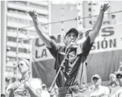  ??  ?? Opposition leader Henrique Capriles delivers a speech next to Lilian Tintori, wife of detained opposition leader Leopoldo López, during a rally in Caracas, Venezuela, on Saturday.