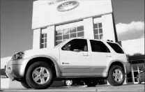  ??  ?? A 2006 Ford Escape hybrid four-wheel drive vehicle is on display outside a Ford agency in Broomfield, Colo. Despite a recent decline, gas prices are still a major factor in car buyers’ minds, analysts say.