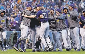  ??  ?? The Brewers celebrate their sweep of the Rockies on Sunday and advancemen­t to the NLCS for the first time since 2011. RUSSELL LANSFORD/USA TODAY SPORTS