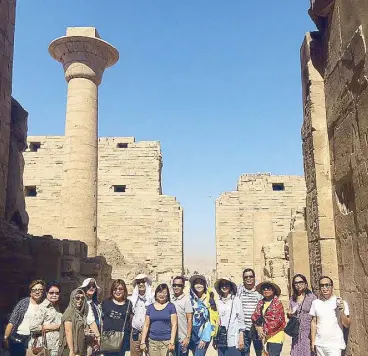  ??  ?? At the Karnak Temple in Luxor are (from left) Baby and Maring Sumulong, Victoria Chua, Celia Atendido, Anna Lissa Ayo, Fr. Bernabe dela Cruz, Vangie and Eric Faraon, Carmina Orbe, Bebot and Bien Estanislao, Ching Nejal, the author Christine Dayrit and...