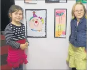  ??  ?? Jade and Ava Charman from Papatawa School stand by their paintings, Ava’s inspired by Salvador Dali’s elephants with long legs.