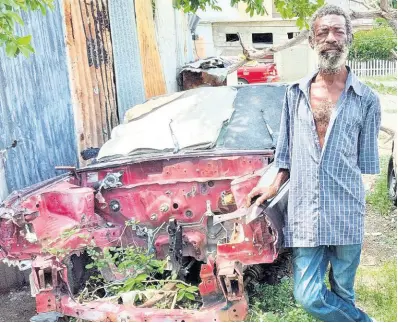  ?? PHOTO BY JASON CROSS ?? Residents of Mexico in Arnett Gardens are seeking assistance to get 58-year-old deaf-mute Patrick Duncan a home so he can move out of this abandoned car and into a home.