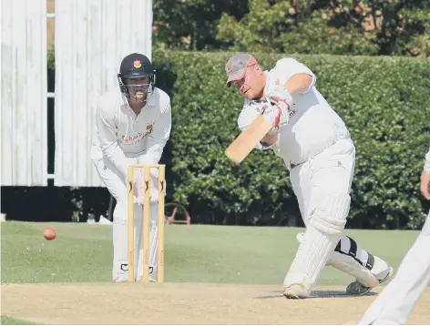  ??  ?? Gary Freear gives it a whack for Wisbech against Oundle in the John Wilcox Cup final.