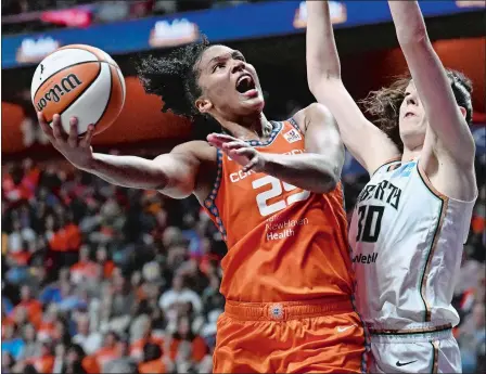  ?? JESSICA HILL/AP PHOTO ?? Connecticu­t Sun forward Alyssa Thomas. left, goes to the basket as New York Liberty forward Breanna Stewart defends during the WNBA semifinals last season at Mohegan Sun Arena. The Sun open the season at 7:30 tonight against the Indiana Fever and recent Iowa AllAmerica­n Caitlin Clark at a sold-out Mohegan Sun.