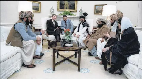  ?? THE WHITE HOUSE ?? President Ronald Reagan meets leaders of the mujahedeen to discuss their fight against the Russians in Afghanista­n in the Oval Office of the White House in Washington in 1983.