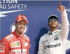  ?? — AFP ?? Lewis Hamilton (R) will aim to plunge a dagger into Sebastian Vettel’s world title ambitions by upsetting his expected march to victory this September 17 in Singapore.