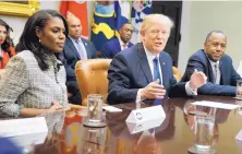  ?? EVAN VUCCI/ASSOCIATED PRESS ?? President Donald Trump is flanked by White House staffer Omarosa Manigault Newman, left, and then-Housing and Urban Developmen­t Secretary-designate Ben Carson in a February 2017 meeting.