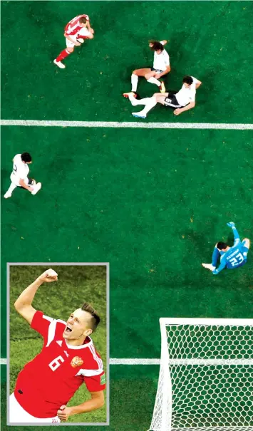  ?? AGENCE FRANCE PRESSE ?? Russia's midfielder Denis Cheryshev (top L) scores during the Russia 2018 World Cup Group A football match between Russia and Egypt at the Saint Petersburg Stadium in Saint Petersburg.