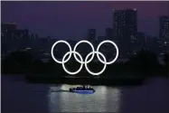  ?? THE ASSOCIATED PRESS ?? In this June 3, 2020, photo, the Olympic rings float in the water at sunset in the Odaiba section in Tokyo. Masa Takaya, the spokesman for the Tokyo Olympics, said Thursday, July 9, 2020, he’s confident the postponed games can be held in 2021 despite a recent poll in Japan in which 77% of respondent­s said they did not believe the games could be held next year.