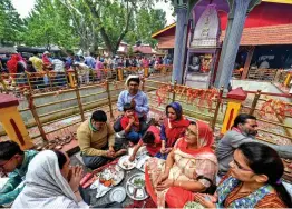  ?? — PTI ?? A Kashmiri Pandit family offers prayers at Kheer Bhawani temple as they celebrate the annual Khir Bhawani Mela at Tulla Mulla in Ganderbal district of central Kashmir on Wednesday.