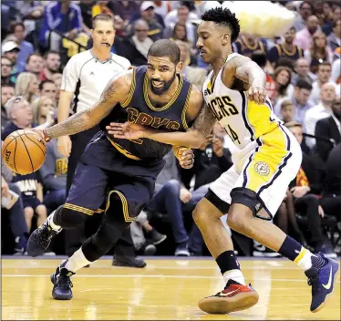  ?? AP/DARRON CUMMINGS ?? Cavaliers 106, Pacers 102
Cleveland guard Kyrie Irving (left) is stopped along the baseline by Indiana defender Jeff Teague during Game 4 of their NBA Eastern Conference playoff series Sunday in Indianapol­is. The Cavaliers completed a four-game sweep...