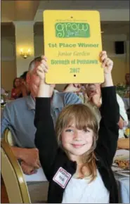  ?? PHOTOS BY MICHILEA PATTERSON — DIGITAL FIRST MEDIA ?? Madeleine Heidel, of Pottstown, holds up the first place plaque she received for winning the “Junior Garden” category.