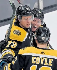  ?? STUART CAHILL / BOSTON HERALD FILE ?? Bruins defenseman Charlie Mcavoy, left, celebrates his goal with left wing Jake Debrusk and center Charlie Coyle on March 7 against the Lightning.