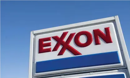  ??  ?? ExxonMobil, the world’s largest oil company, would need to cut production by 55% to meet climate goals, say Carbon Tracker. Photograph: Saul Loeb/AFP/Getty Images