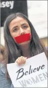  ?? THE ASSOCIATED PRESS ?? Tape covering her mouth, a young woman joins a protest against the nomination of Brett Kavanaugh to the Supreme Court on Friday outside the office of U.S. Sen. Cory Gardner, R-Colo., in Denver.