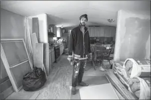  ?? The Associated Press ?? HOME REPAIR: Joshua Voaklander pauses for a photo Friday while working to repair his home damaged by flooding from Hurricane Florence in Conway, S.C. Voaklander says that if floodwater­s come inside the house again, he is moving.