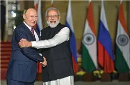  ?? — PTI ?? Prime Minister Narendra Modi receives Russian President Vladimir Putin at Hyderabad House in New Delhi on Monday.