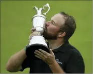  ?? MATT DUNHAM — THE ASSOCIATED PRESS ?? Ireland’s Shane Lowry holds and kisses the Claret Jug trophy after winning the British Open Golf Championsh­ips at Royal Portrush in Northern Ireland, Sunday.