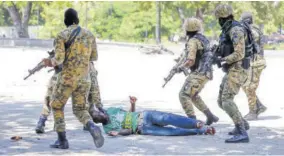  ??  ?? Presidenti­al Guards detain a man during clashes with mourners and demonstrat­ors who were carrying the coffins with the remains of two victims of the ongoing violence, near the Presidenti­al Palace in Port-au-prince, Haiti, yesterday.