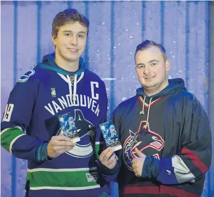  ?? PHOTOS: GERRY KAHRMANN/PNG ?? Chris Foreman, left, whose family has had Canucks season tickets since 1992, attends Thursday’s game with Alex Friesen. He said it’s ‘still a good experience’ at Rogers Arena.