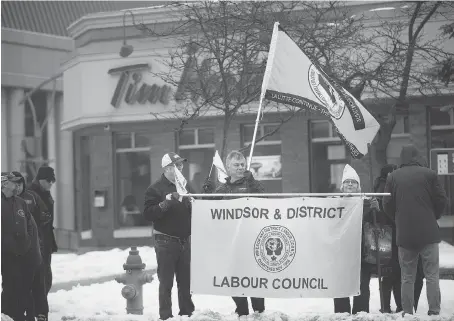  ?? DAX MELMER ?? Labour leaders demonstrat­e outside the downtown Windsor Tim Hortons at Park Street East and Goyeau Avenue on Wednesday, part of a provincewi­de protest against the coffee chain clawback of employee benefits in reaction to the increase in Ontario’s...