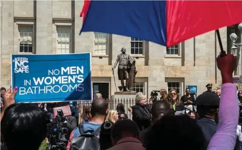  ?? Ray Whitehouse / The New York Times ?? Supporters of a state bill restrictin­g bathroom access to transgende­r people rally in Raleigh, N.C., in April.