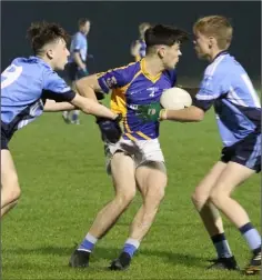  ??  ?? Cathal Murphy of Cluáin O’Rahilly’s is tackled by his St. Anne’s namesake, Cathal Murphy (right), and Liam Berry.