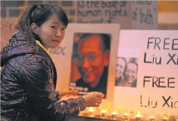  ?? REUTERS ?? An Australian Tibetan community member attends a vigil for Liu Xiaobo at the Chinese consulate in Sydney on Wednesday.