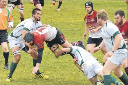  ?? KEITH GOSSE/THE TELEGRAM ?? The Rock’s Noel Strapp is prone to the ground as he is tackled by a couple of New Brunswick Spruce players their Eastern Canadian Super League rugby game at the Swilers rugby complex Saturday afternoon.