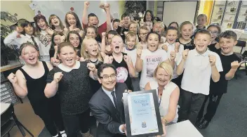  ??  ?? Editor Ed Asquith presented previous winner Dee McCulloch with her award as her Cayton School class cheered.