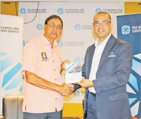  ?? Picture: SUPPLIED ?? Fiji Revenue and Customs Service CEO Visvanath Das hands over the Code of Conduct for Customs, Shipping and Airline Agents to CBFCF Board member Ram Rajend.