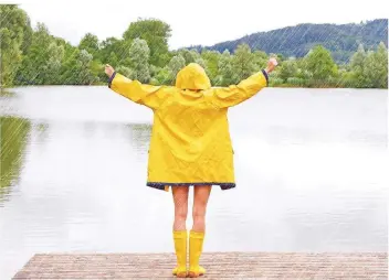  ?? FOTO: JÜRGEN FÄLCHLE/FOTOLIA ?? Diese Frau erlebt im strömenden Regen am See einen Moment des Glücks.