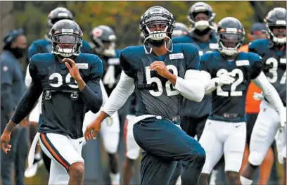  ?? BRIAN CASSELLA/CHICAGO TRIBUNE ?? Linebacker Khalil Mack (52) and his Bears teammates warm up at a training camp practice on Aug. 25 at Halas Hall.