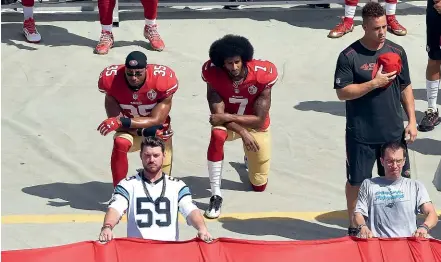  ?? GETTY IMAGES ?? Colin Kaepernick, right, and Eric Reid of the San Francisco 49ers kneel during the national anthem in 2016.